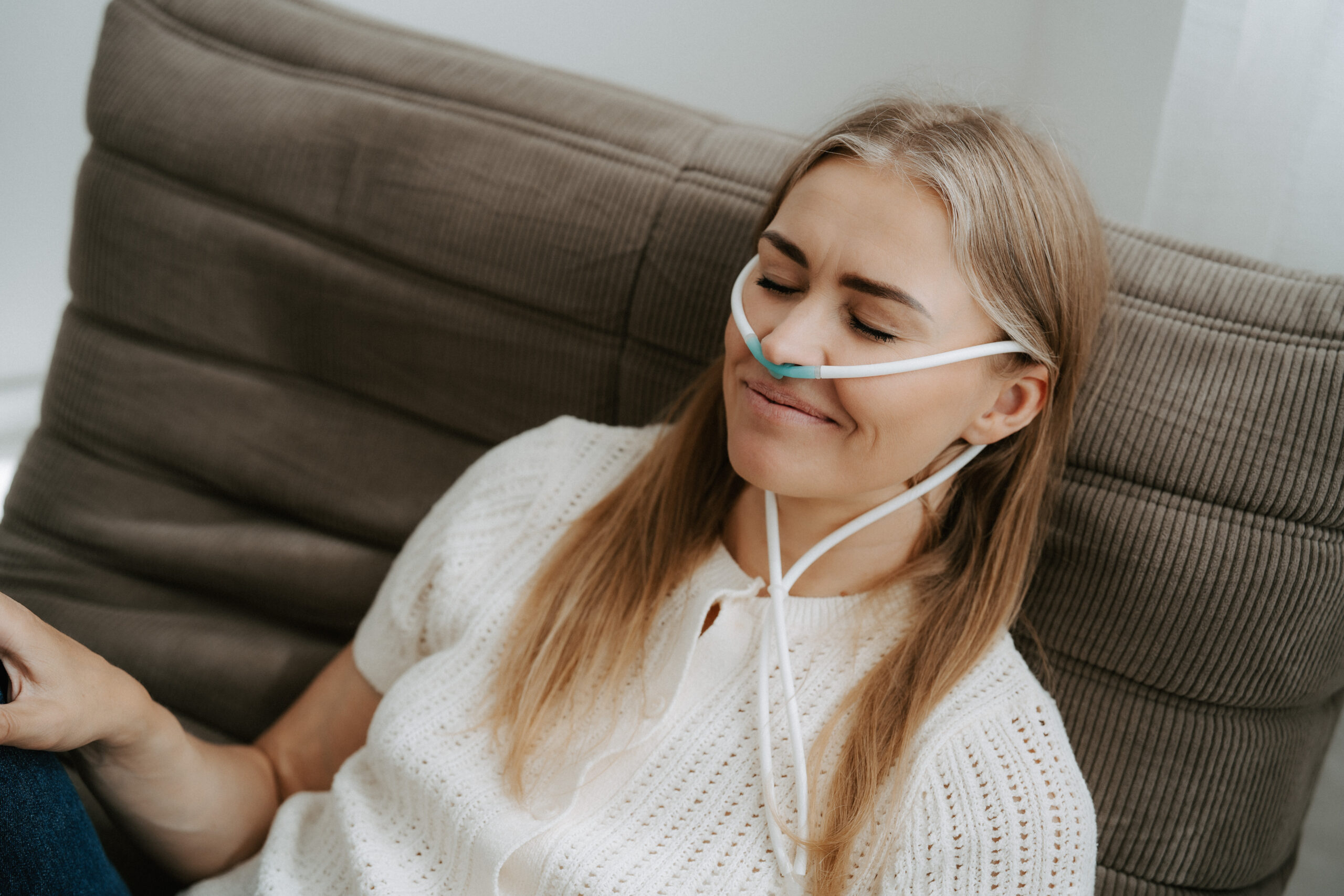 Woman inhaling hydrogen through a nasal cannula